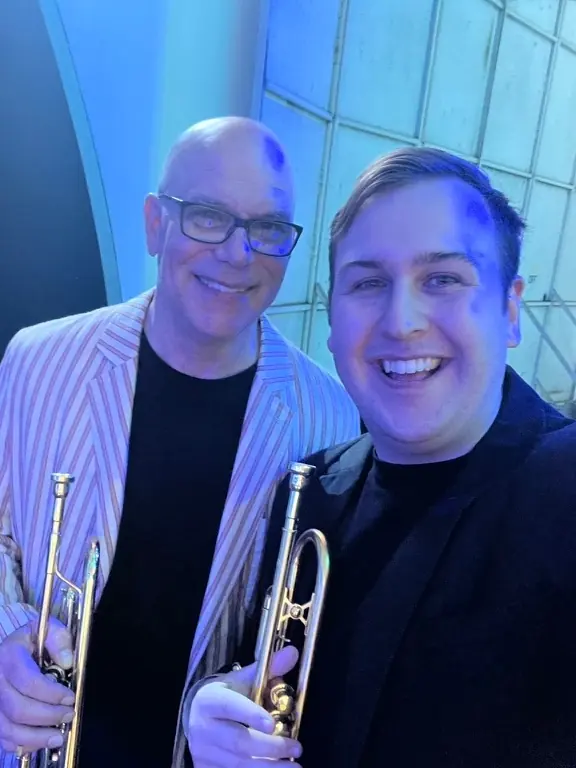 Harrisson Ball smiling with his trumpet backstage at the Hollywood Bowl shell