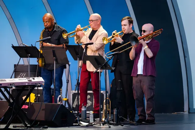Harrisson Ball playing trumpet with three other horn players on the Hollywood Bowl stage
